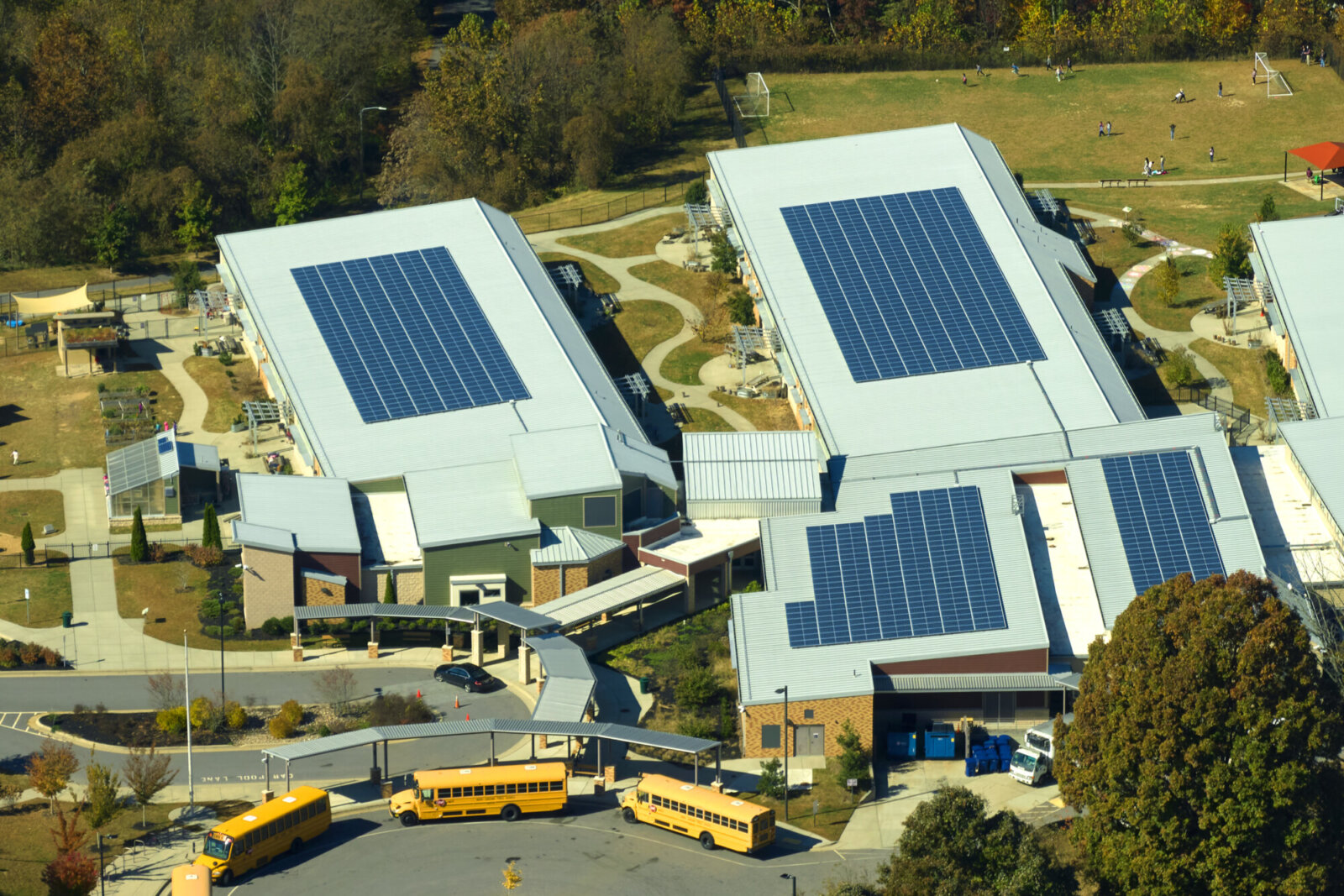 Image of solar panels on the rooftop of a school building