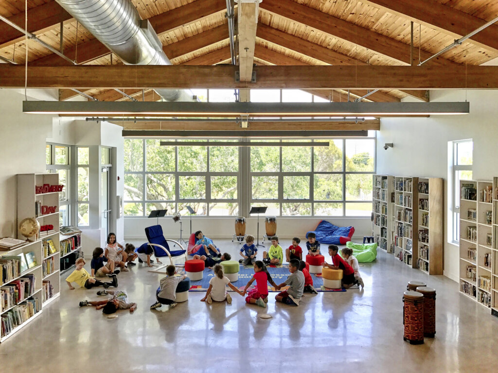 Children sitting in a light-filled classroom