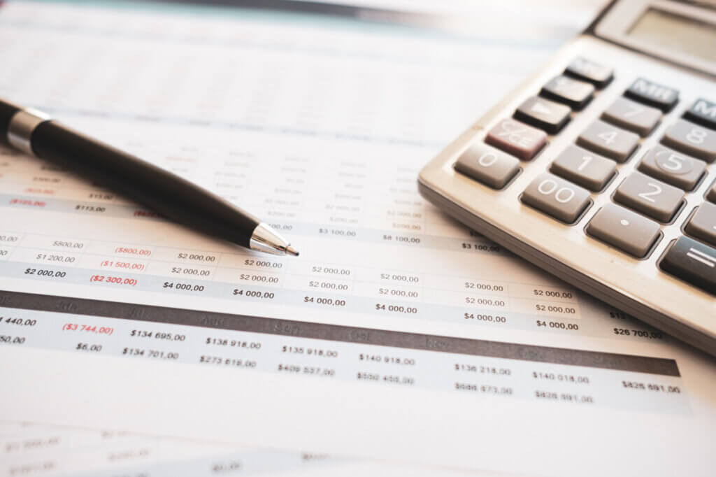 budget scene featuring a calculator pen, and a spreadsheet